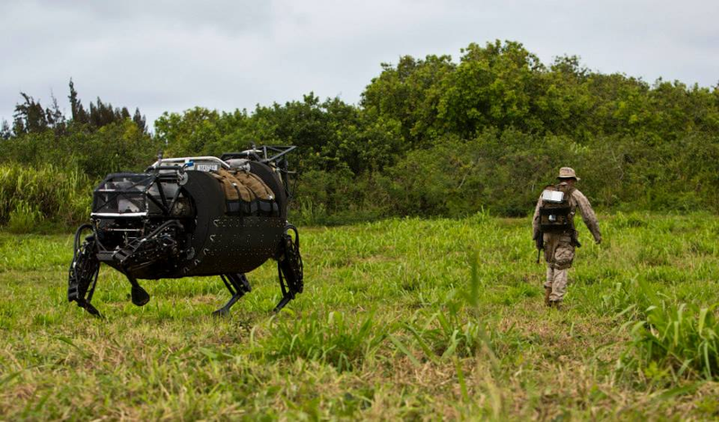 The Legged Squad Support System (LS3) on patrol with a Marine during the Advanced Warfighting Experiment. Source: Kyle Olson via The United States Marine Corps
